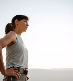 Woman outside taking deep breaths. 
