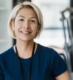 A woman smiling and looking at the camera.