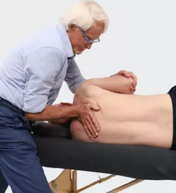 Massage therapist Erik Dalton works on a client's back.