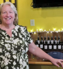 Debbie Pennington stands in the building where she practices massage. 