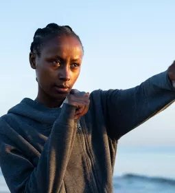 A woman throws a punch.