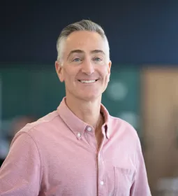Portrait image of Darren Buford in a pink button-down shirt.