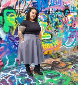 Leslie DeJesus poses for a photo in Graffitti Alley in Baltimore. 