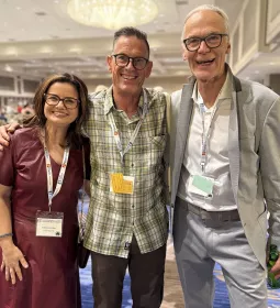 Three people pose for a photo in a conference room at the 7th Fascia Research Congress.