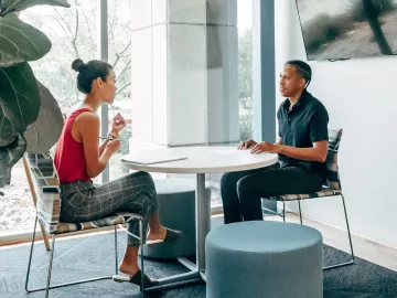 A man and woman conducting a job interview in an office setting.