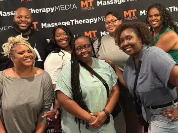 Attendees at the inaugural Black Massage Therapist Conference smile for a photo.