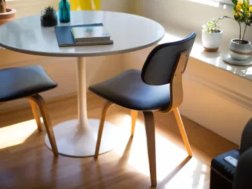 journals and notebooks sit on a round table.