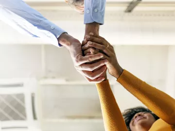 two people clasping their hands together.