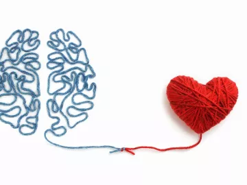 blue threads make the shape of a brain that lead to red threads that form the shape of a heart.
