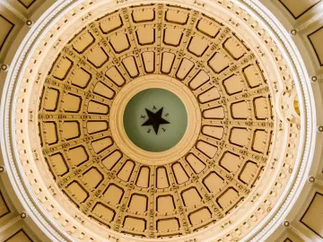 gold adorned dome ceiling of a court or government building.