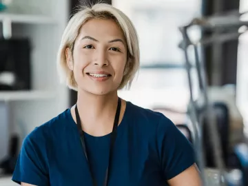 A woman smiling and looking at the camera.