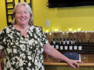 Debbie Pennington stands in the building where she practices massage. 